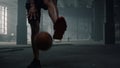Man bouncing basketball ball between legs. Male player playing basketball Royalty Free Stock Photo