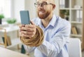 Man with Bound Hands Using Smartphone Engrossed in Online Entertainment Royalty Free Stock Photo