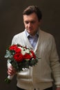 A man with a bouquet of roses