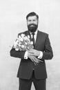 Man with bouquet tulips. prepare for mothers day holiday. flower surprise for her. bearded man in formal suit greeting