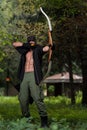Man With A Bow And Arrows In Woods Royalty Free Stock Photo