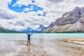 Man at Bow Lake With Crowfoot Glacier and Crowfoot Mountain