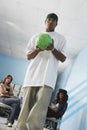 Man Bowling With Female Friends In Background Royalty Free Stock Photo