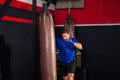 Man boxer exercising punches with boxing bag in gym, Boxer hitting a huge punching bag at a boxing studio Royalty Free Stock Photo