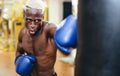 Man boxer training hard - Young black guy boxing in sport gym center club Royalty Free Stock Photo