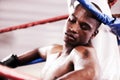 Man, boxing ring and workout rest or exercise sweat, professional athlete or tired burnout. Black person, exhausted and Royalty Free Stock Photo