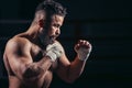 Man boxing workout on ring. Caucasian male boxer in black gloves