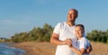 Man and a boy are standing on a beach Royalty Free Stock Photo