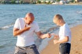 Man and a boy are standing on the beach Royalty Free Stock Photo