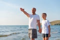Man and a boy are standing on the beach Royalty Free Stock Photo