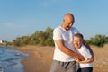 Man and a boy are standing on a beach Royalty Free Stock Photo
