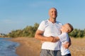 Man and a boy are standing on a beach Royalty Free Stock Photo