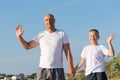 Man and a boy are standing on a beach Royalty Free Stock Photo