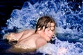 Man or boy in a water spalshing Royalty Free Stock Photo