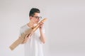 Man with Bread in hand. Freshly baked bread in the hands. .. Nerd is wearing glasses holding a lot of bread in hands