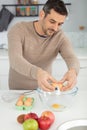 man breaking eggs while cooking at home Royalty Free Stock Photo