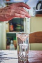 Man breaking the ice, cooling water in a glass Royalty Free Stock Photo