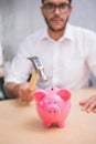 Man breaking piggy bank with hammer Royalty Free Stock Photo