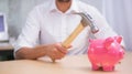 Man breaking piggy bank with hammer Royalty Free Stock Photo