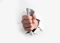 Man breaking through white paper with money in fist, closeup Royalty Free Stock Photo