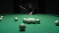 A man a man breaks a pyramid of white billiard balls. Start playing Russian billiards Royalty Free Stock Photo