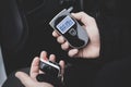 a man with a breathalyzer in the car, Royalty Free Stock Photo