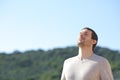 Man breathing fresh air near the mountains