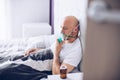 Man breathing through oxygen mask in bed. Covid-19 patient. Royalty Free Stock Photo