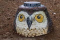 A man brick man hole with a brown owl painted on front at Murphey Candler Park in Atlanta