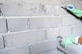 Man bricklayer is Marking points to find the level of the cement brick block wall construction Royalty Free Stock Photo