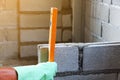 Man bricklayer is Measurement level vertical In the brick block cement wall construction Royalty Free Stock Photo