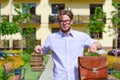 Man with briefcase and pile of old books in yard Royalty Free Stock Photo