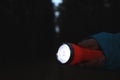 Man with bright flashlight at night