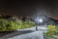 Man with a bright glowing lantern in his hand goes at night