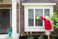 Man washing the bump-out or bay windows