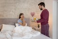 Man bringing breakfast tray to woman in bed Royalty Free Stock Photo