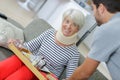 Man bringing tray food to injured mother