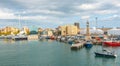 Man brings his sailboat dead slow into Port Vell Marina in Barcelona, Spain. Royalty Free Stock Photo