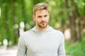 Man with bristle on calm face, nature background, defocused. Skin care concept. Man with beard or unshaven guy looks Royalty Free Stock Photo