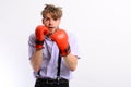 Man with bristle and scared face wears boxing gloves.