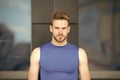 Man bristle serious face muscular shoulders, urban background, defocused. Metrosexual concept. Guy bearded and Royalty Free Stock Photo