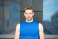 Man bristle serious face muscular shoulders, urban background, defocused. Metrosexual concept. Guy bearded and Royalty Free Stock Photo