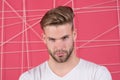 Man with bristle on strict concentrated face, pink background. Guy bearded and attractive with hairstyle. Masculinity Royalty Free Stock Photo