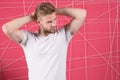 Man with bristle strict face enjoy freshness of hair, pink background. Guy bearded attractive with hairstyle. Man with