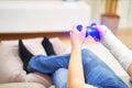 Man with broken arm in plaster cast holding controller and playing in videogame in front of TV. Game addiction concept. Royalty Free Stock Photo