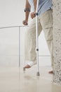 Man With Broken Leg Walking With Crutches