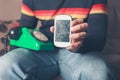 Man with broken smart phone and rotary telephone