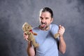 Man with broken teddy bear looking bad Royalty Free Stock Photo