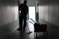 Man with broom cleaning office corridor Royalty Free Stock Photo