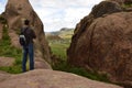 The man on the brown rocks near the Gate of Hayu Mark (The Gate of the Gods), Peru WILLKA UTA, HAYUMARKA GATE. Puno Peru Royalty Free Stock Photo